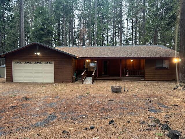 7722 Hidden Meadows Road Shingletown, CA 96088 - Photo 1 of 12 a front view of a house with a yard