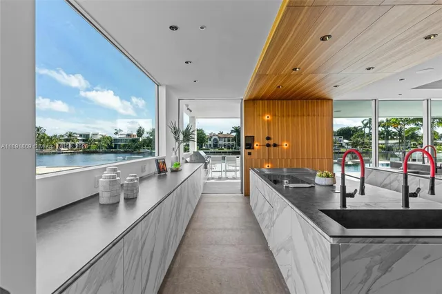 a living room with lots of furniture and a view of kitchen