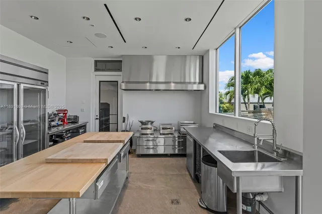 a bedroom with furniture and large windows