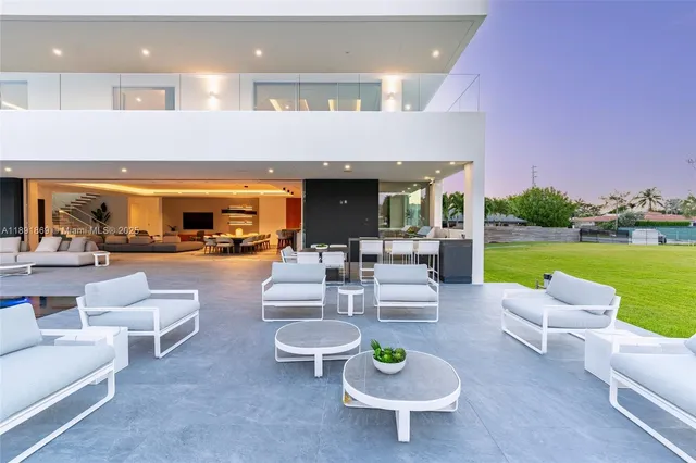 a living room with furniture and a floor to ceiling window