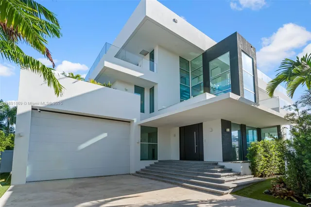 a living room with furniture and large windows