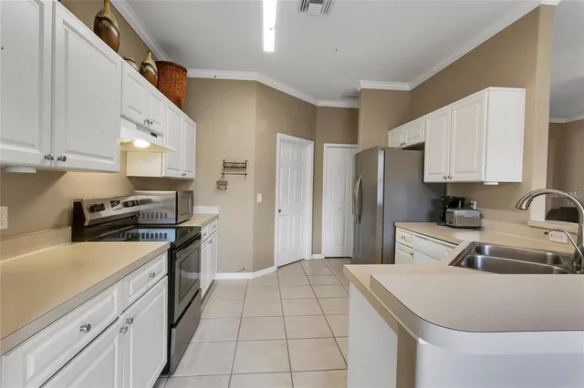 a kitchen with a sink appliances and cabinets