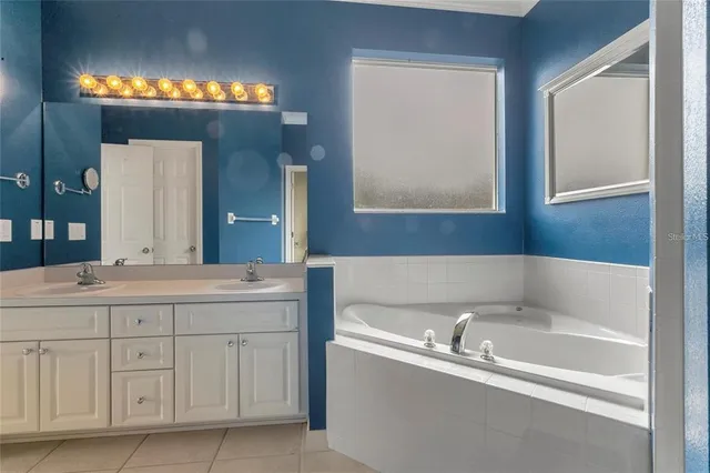 a bathroom with a tub and a sink