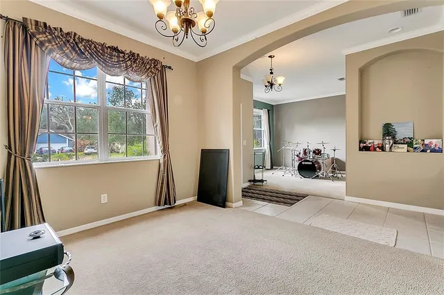 a living room with furniture and a chandelier
