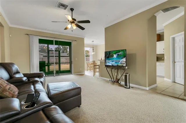 a living room with furniture a window and a flat screen tv