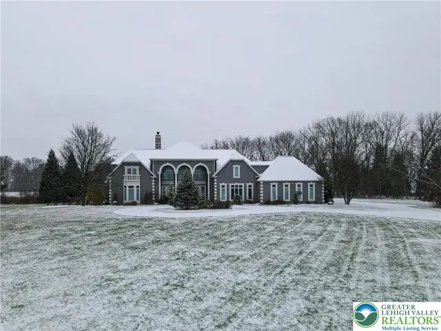 a view of a house with yard and sitting area