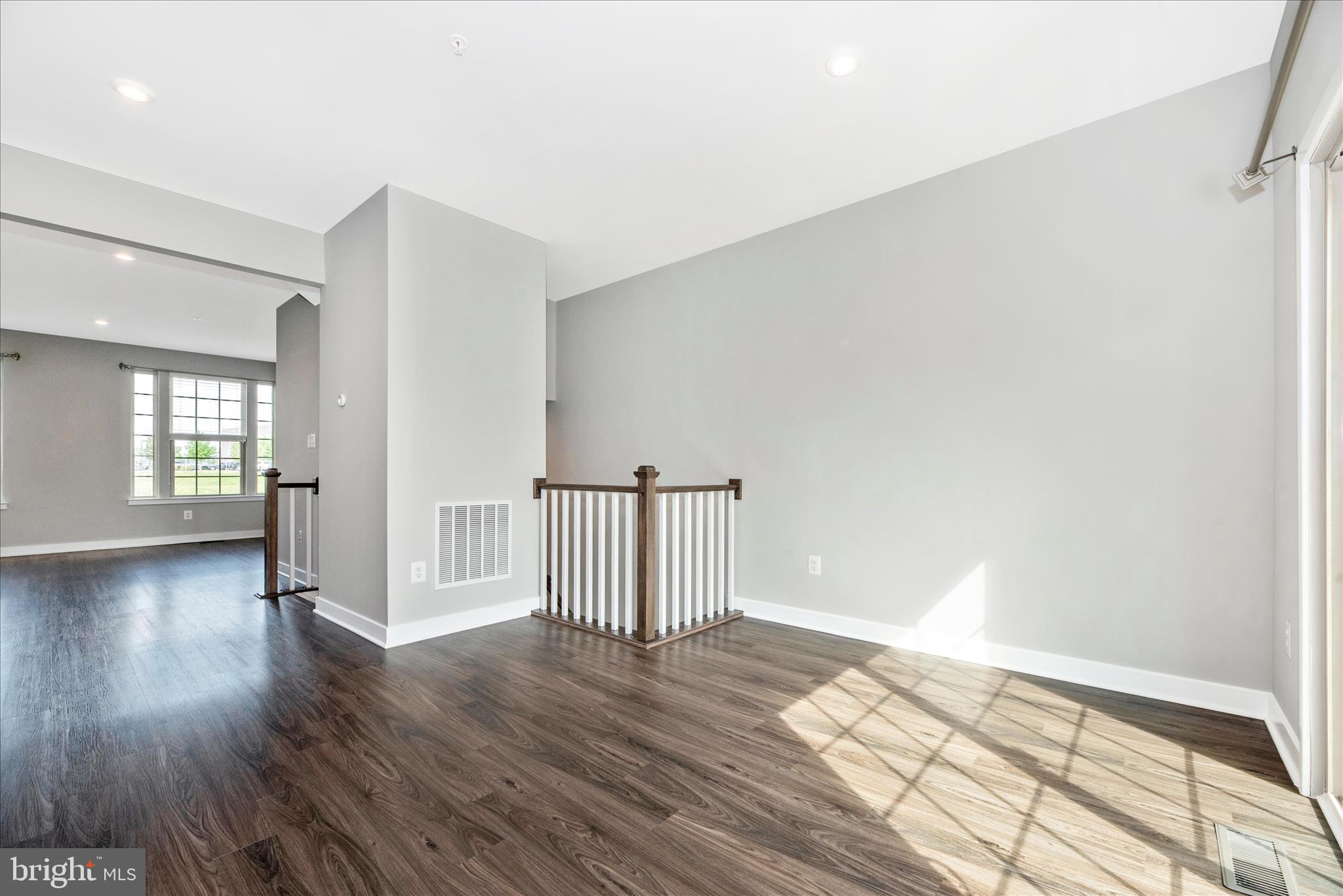 7091 Kokanee Way New Market, MD 21774 - Photo 15 of 69 an empty room with wooden floor and windows