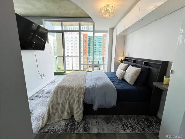 a view of walk in closet with wooden floor