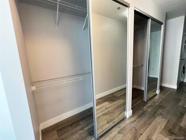 a bathroom with a sink a toilet a mirror a vanity and shower