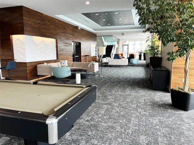 a living room with furniture rug and wooden floor