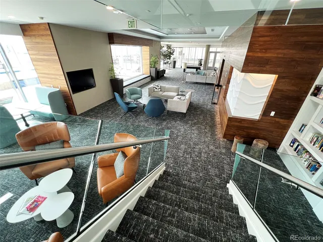 a living room with furniture a flat screen tv and a large window