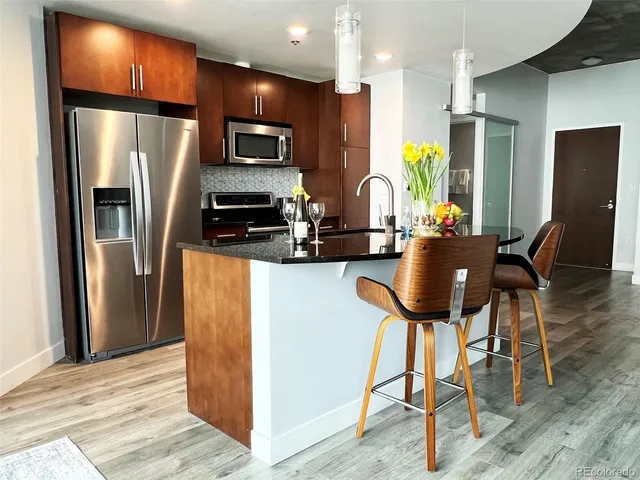 a living room with wooden floor furniture and a table