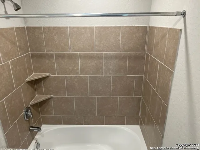 a bathroom with a shower and a sink