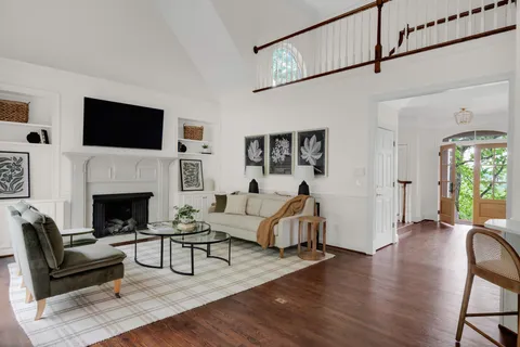 a living room with furniture and wooden floor