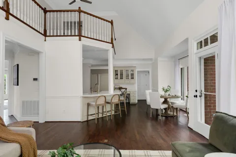 a dining room with furniture and wooden floor