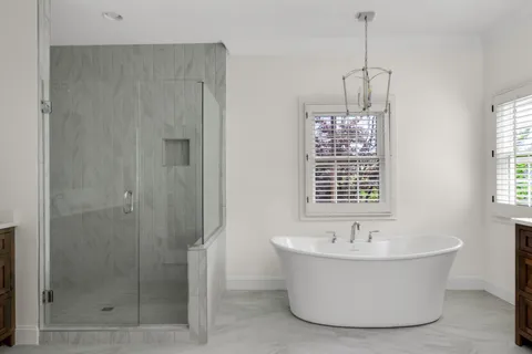 a view of an empty room with a window and a ceiling fan