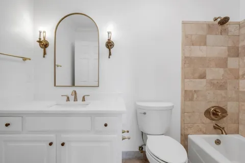 a bathroom with a bathtub and a toilet