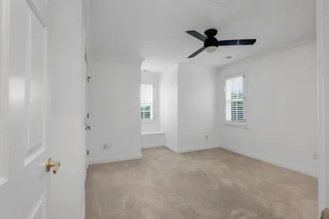 a view of empty room with a ceiling fan