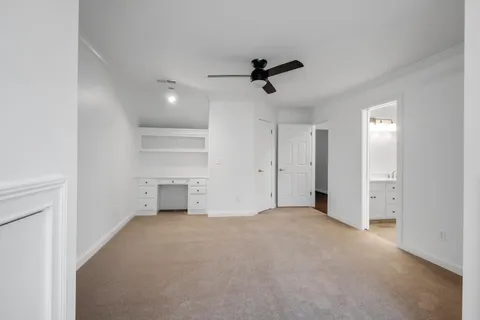 a living room with furniture a flat screen tv and a view of kitchen