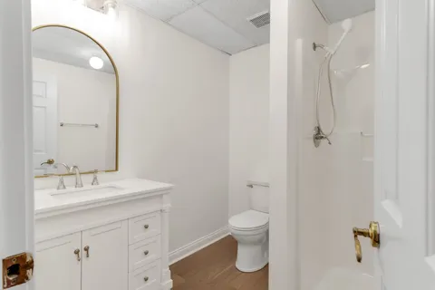 a view of a house with a big yard plants and large trees