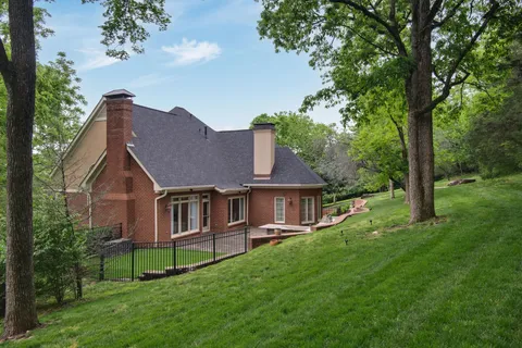 an aerial view of a house with a yard and outdoor seating