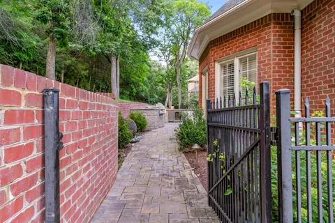 a view of a balcony with floor to ceiling windows and wooden fence