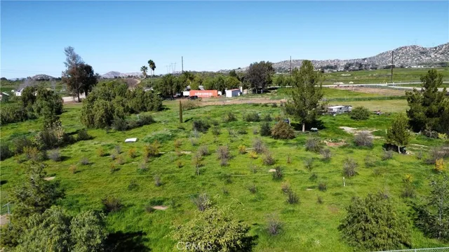 a aerial view of a house with a yard and lake view