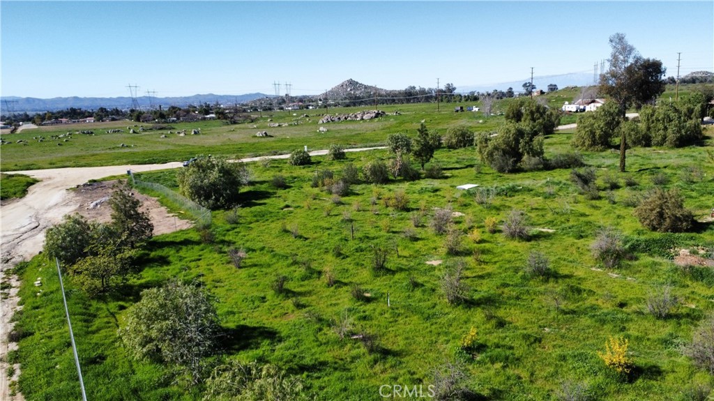 29580 Patelli Way Menifee, CA 92585 - Photo 34 of 38 a view of a lush green outdoor space with a swimming pool and valleys in the background