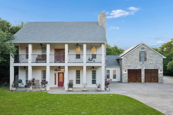 a front view of a house with outdoor seating and yard
