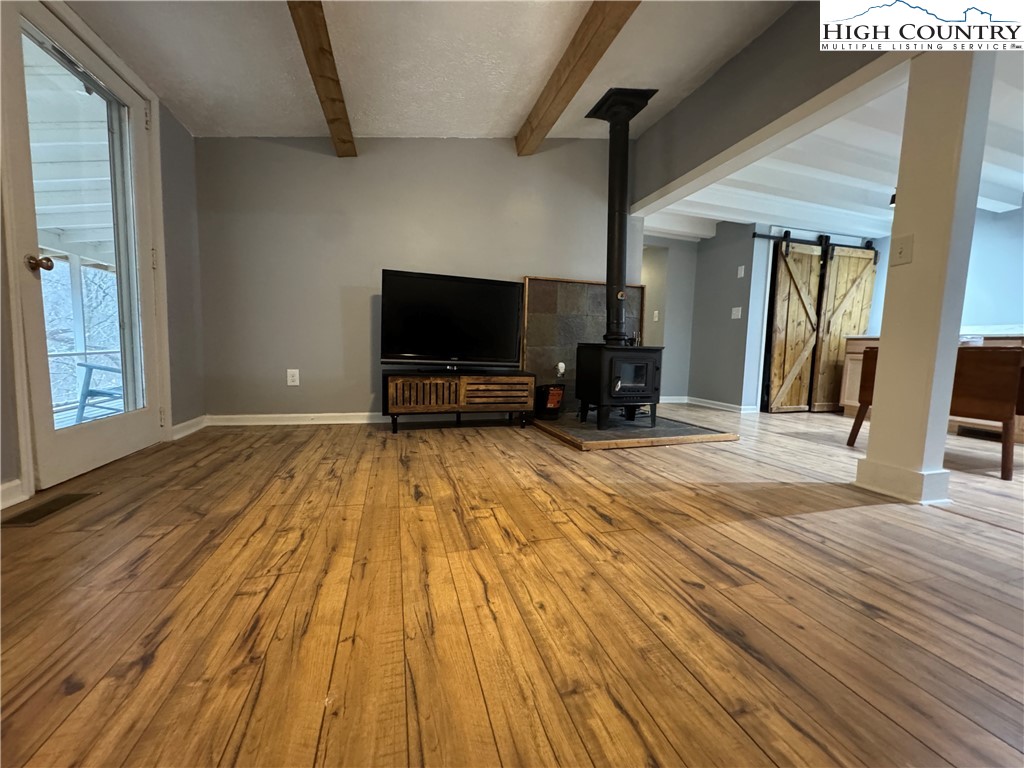 321 Skin Camp Creek Road Todd, NC 28684 - Photo 2 of 29 a view of a livingroom with wooden floor and furniture