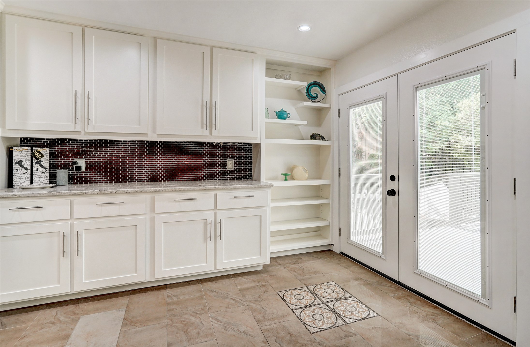8804 Mountain Ridge Drive, Unit A Austin, TX 78759 - Photo 17 of 37 Kitchen featuring light stone countertops, white cabinetry, tasteful backsplash, open shelves, and recessed lighting