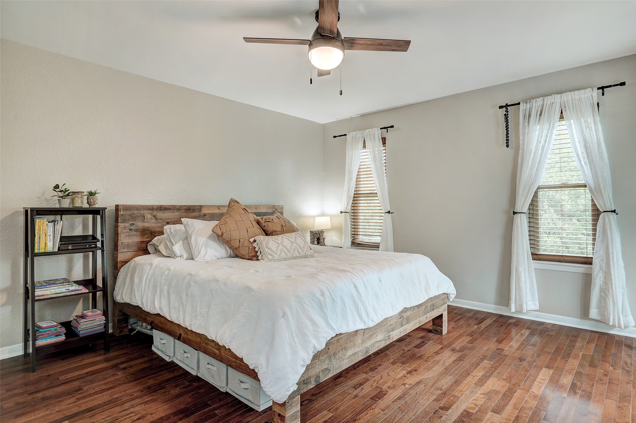 8804 Mountain Ridge Drive, Unit A Austin, TX 78759 - Photo 19 of 37 Bedroom with hardwood / wood-style floors, ceiling fan, and multiple windows