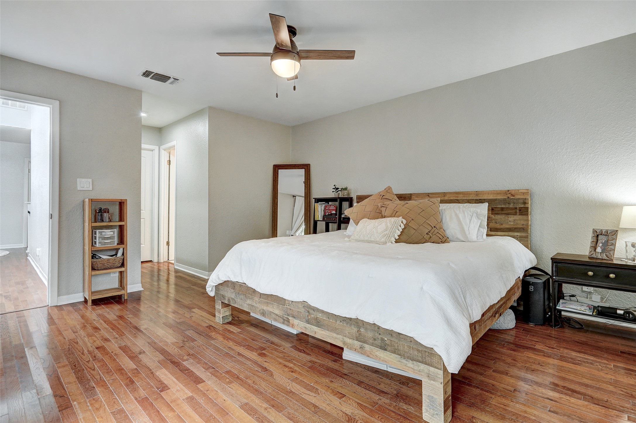 8804 Mountain Ridge Drive, Unit A Austin, TX 78759 - Photo 21 of 37 Bedroom featuring light wood-style floors and a ceiling fan