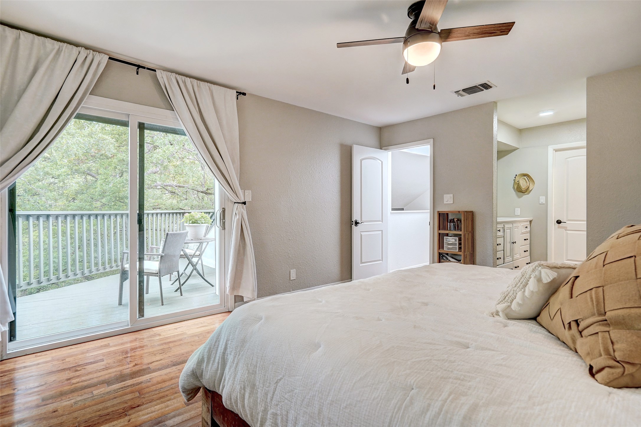 8804 Mountain Ridge Drive, Unit A Austin, TX 78759 - Photo 22 of 37 Bedroom with light wood-style flooring, access to outside, and a ceiling fan