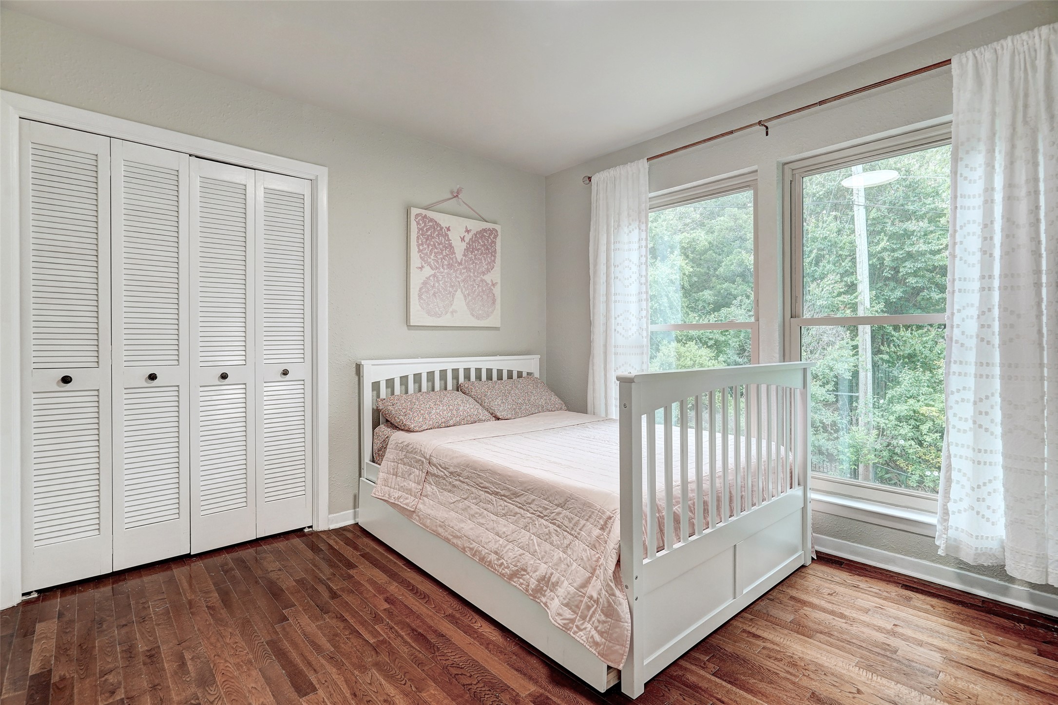 8804 Mountain Ridge Drive, Unit A Austin, TX 78759 - Photo 26 of 37 Bedroom featuring wood finished floors and a closet