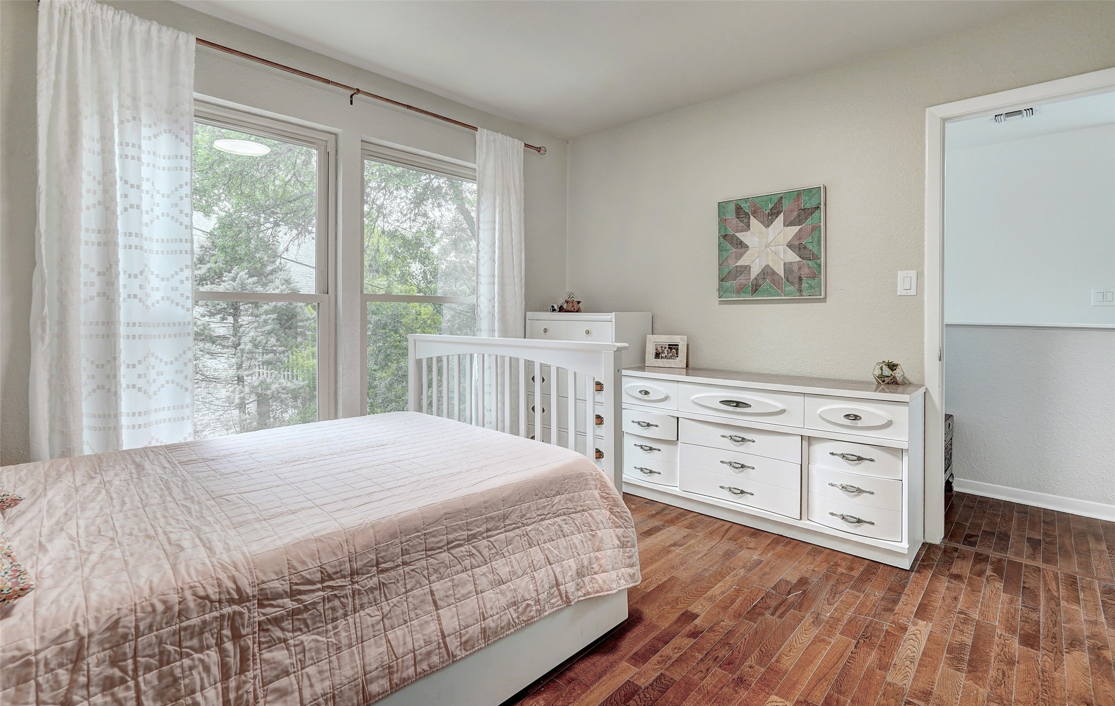 8804 Mountain Ridge Drive, Unit A Austin, TX 78759 - Photo 27 of 37 Bedroom with dark wood-style flooring and baseboards