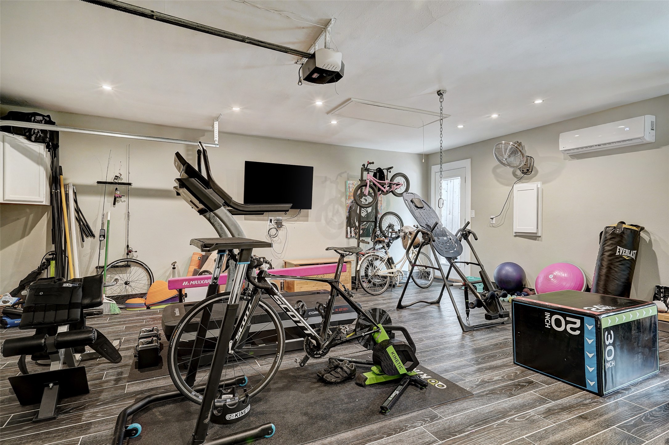 8804 Mountain Ridge Drive, Unit A Austin, TX 78759 - Photo 36 of 37 Garage with a wall mounted mini split, recessed lighting, and a garage door opener
