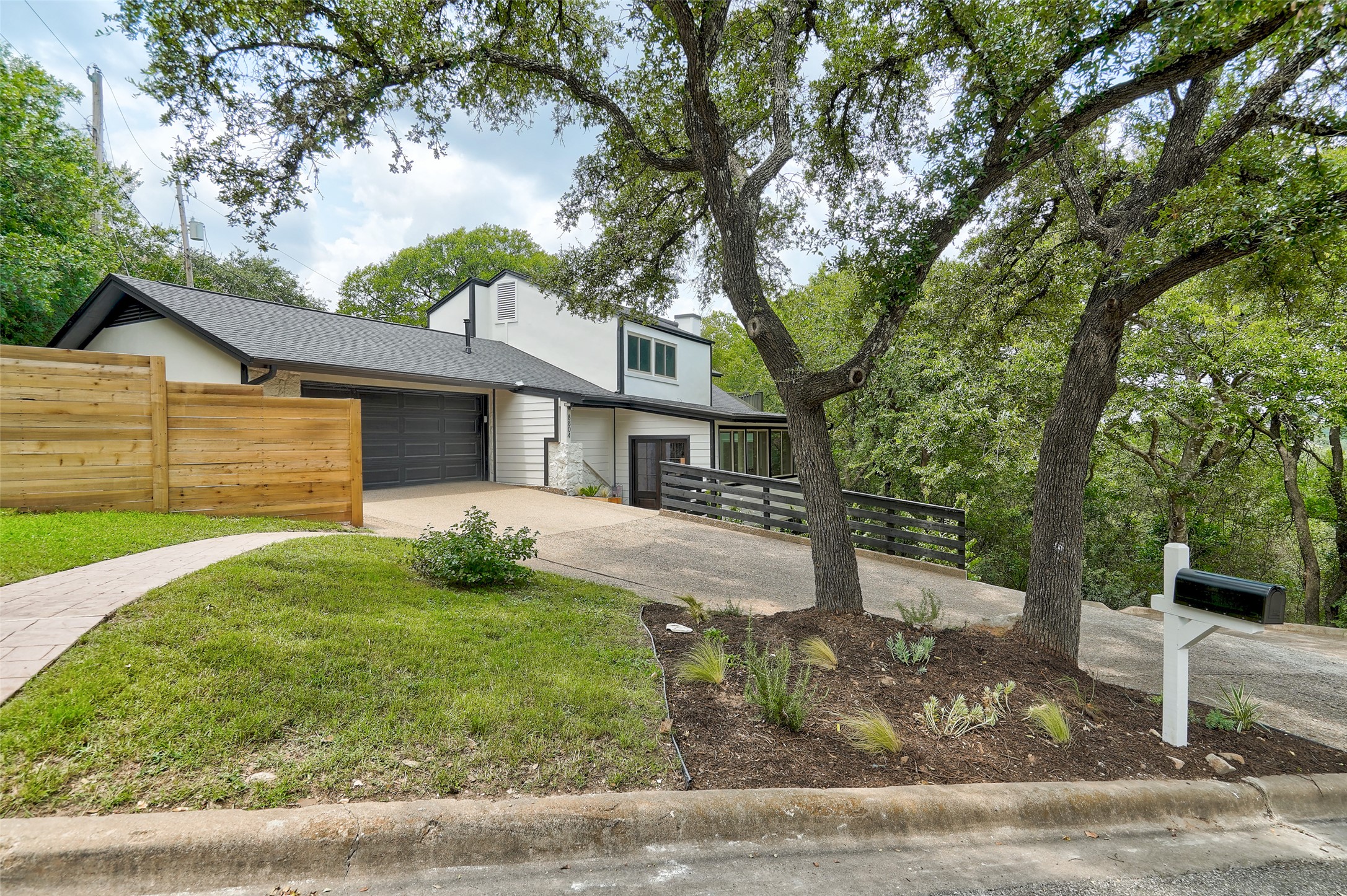 8804 Mountain Ridge Drive, Unit A Austin, TX 78759 - Photo 4 of 37 View of front of property with driveway and a garage