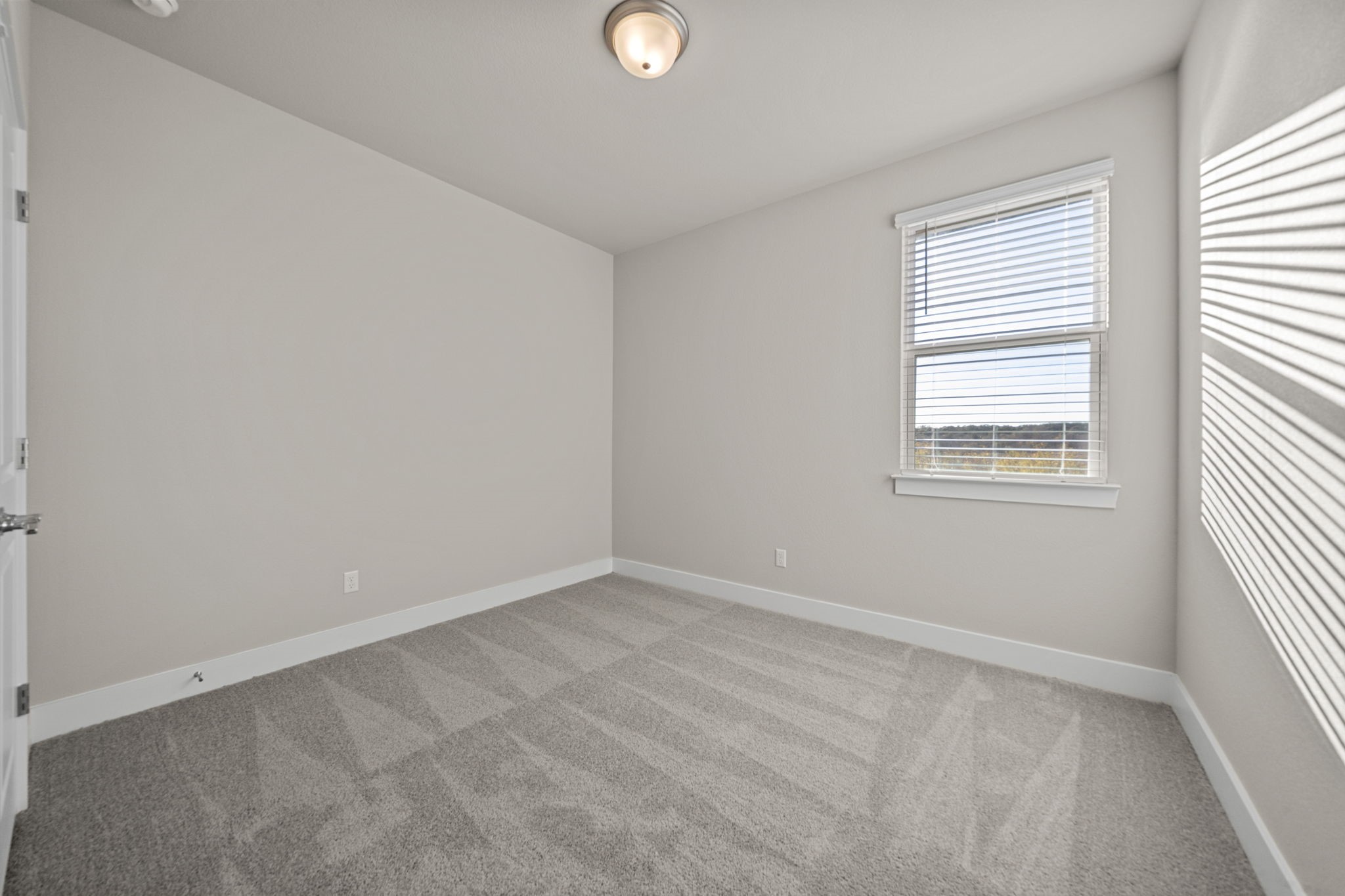 219 Pinnacle Lane Kyle, TX 78640 - Photo 4 of 20 an empty room with windows