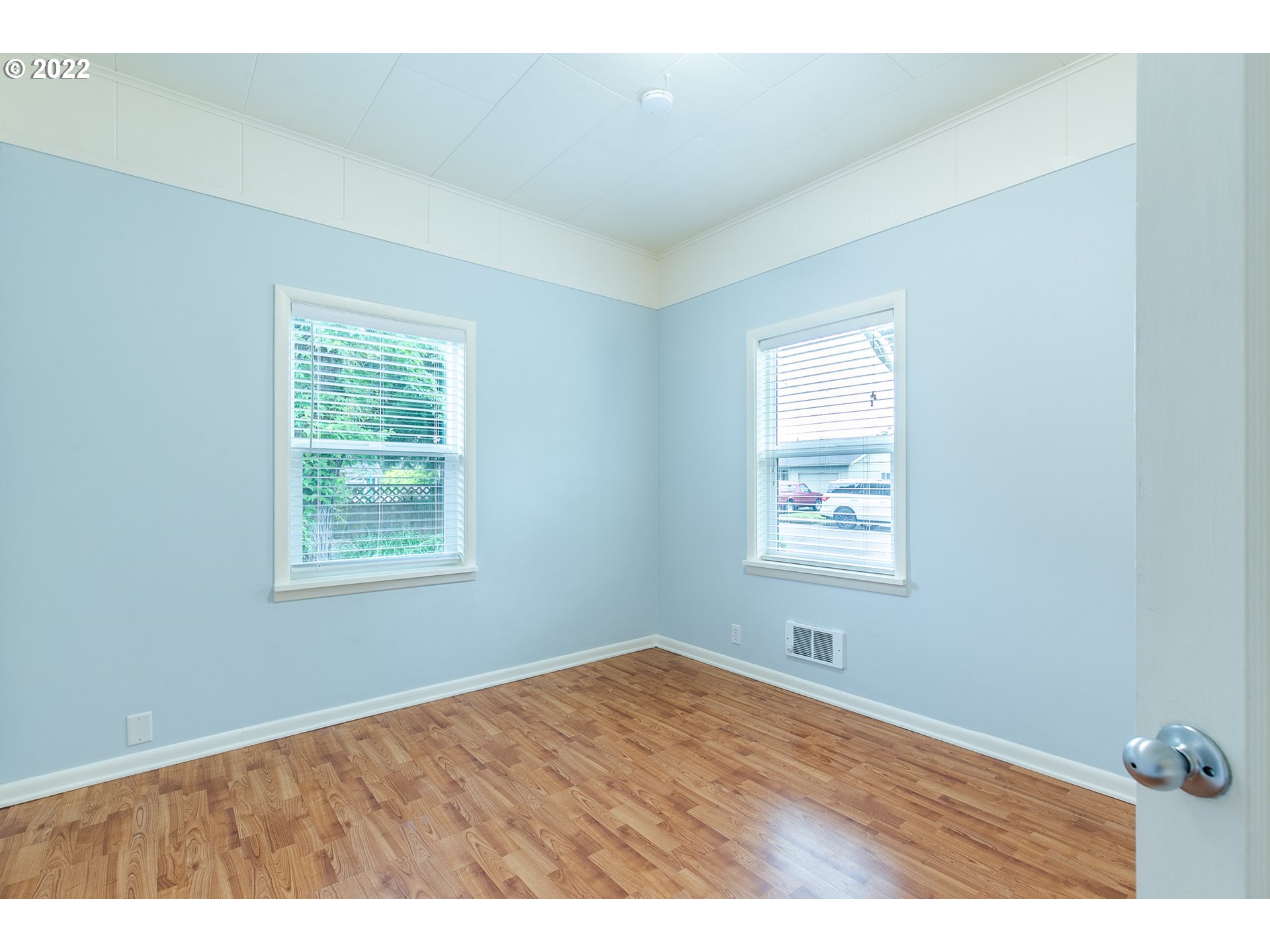 476 U Street Springfield, OR 97477 - Photo 9 of 32 an empty room with wooden floor and windows