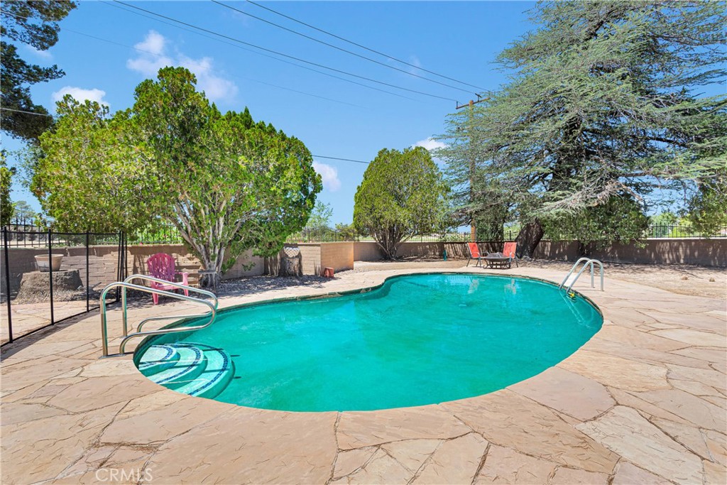 19955 Chickasaw Road Apple Valley, CA 92307 - Photo 43 of 60 a view of a swimming pool with chairs