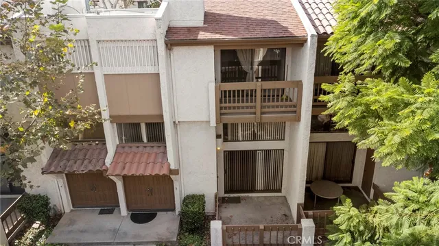 a front view of a house with plants