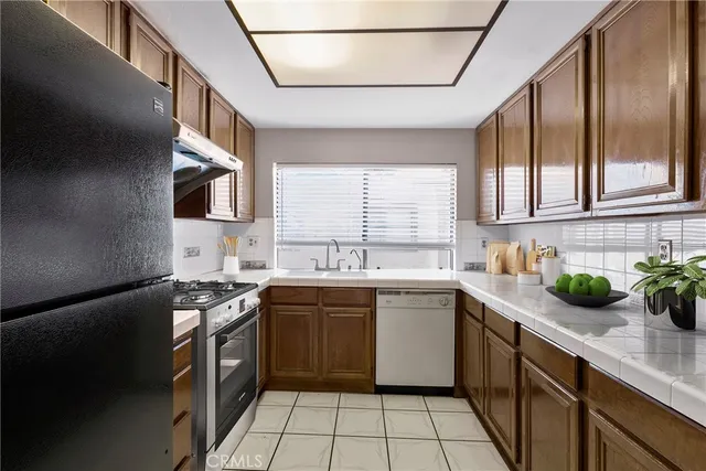a kitchen with a sink a stove and cabinets