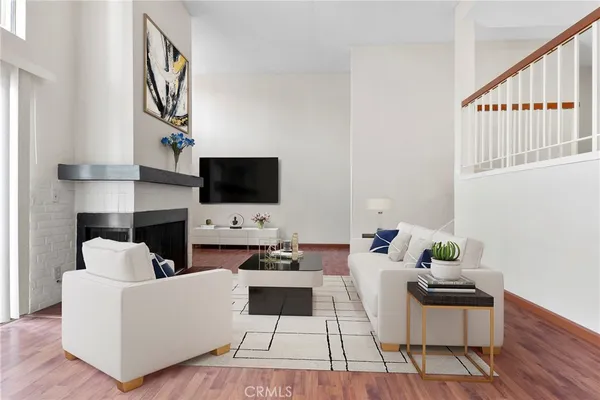 a living room with furniture and a potted plant