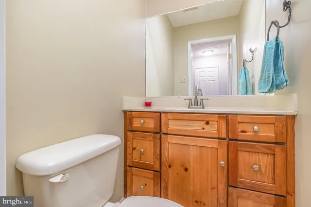 a bathroom with a sink a toilet and mirror