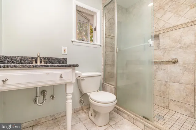 a bathroom with a toilet a sink and a shower