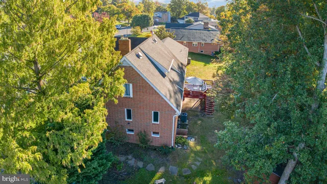 an aerial view of a house with table and chairs