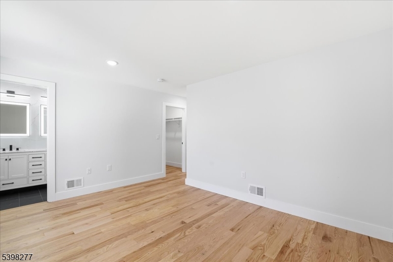 62 Hillside Avenue, Unit 1 Newark, NJ 07108 - Photo 3 of 10 a view of an empty room with wooden floor and closet