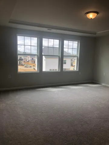 a view of an empty room and closet area