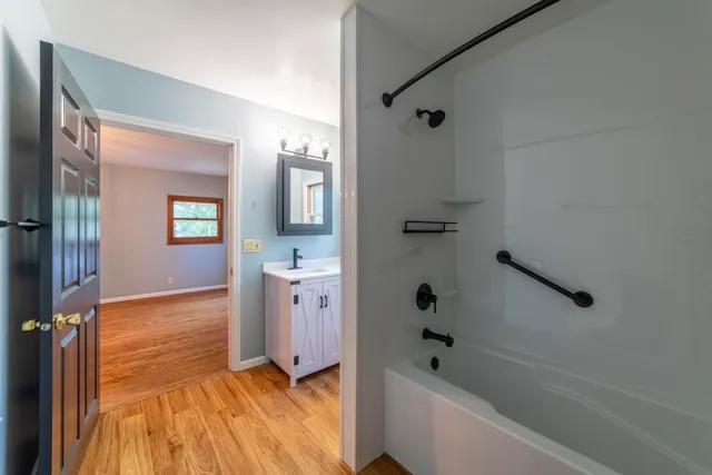a view of an empty room with window and closet area